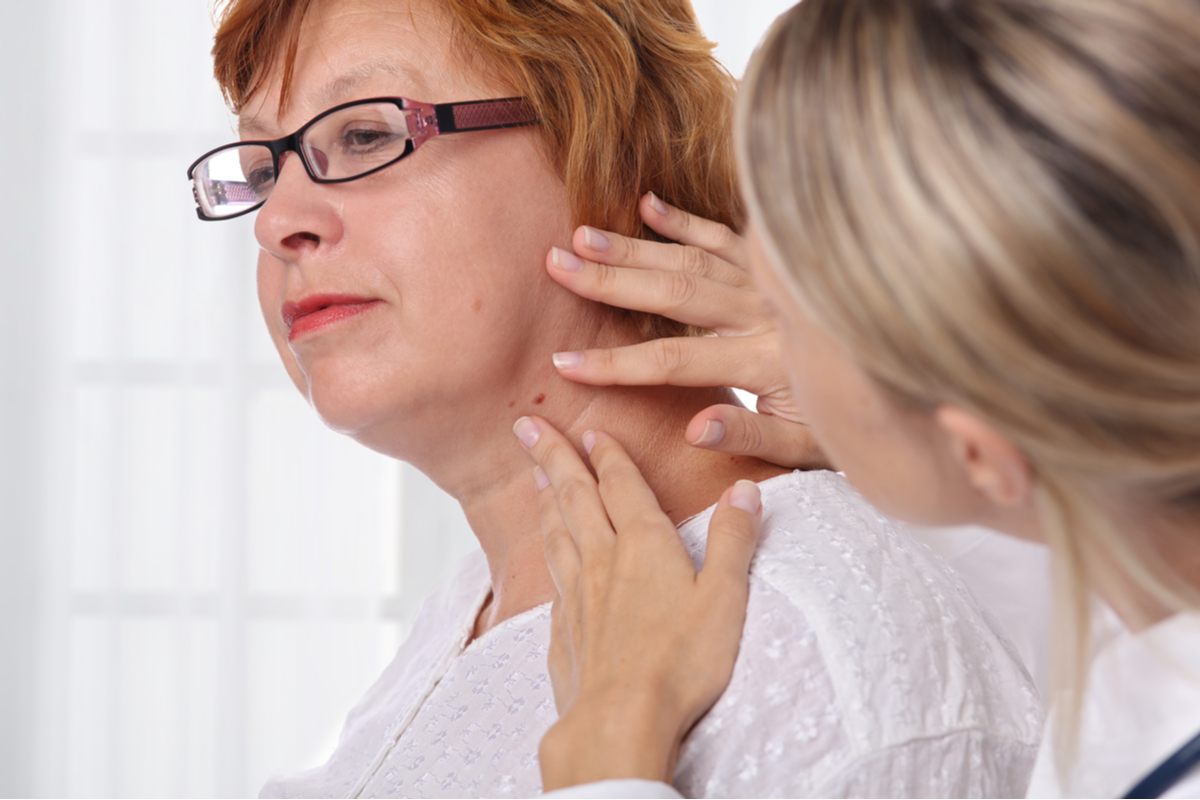 a woman checking another woman's skin